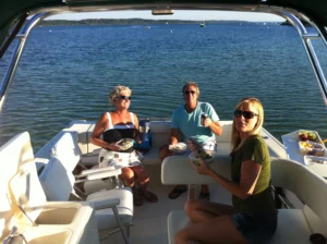 3 people enjoying a snack aboard Ambitious Charters