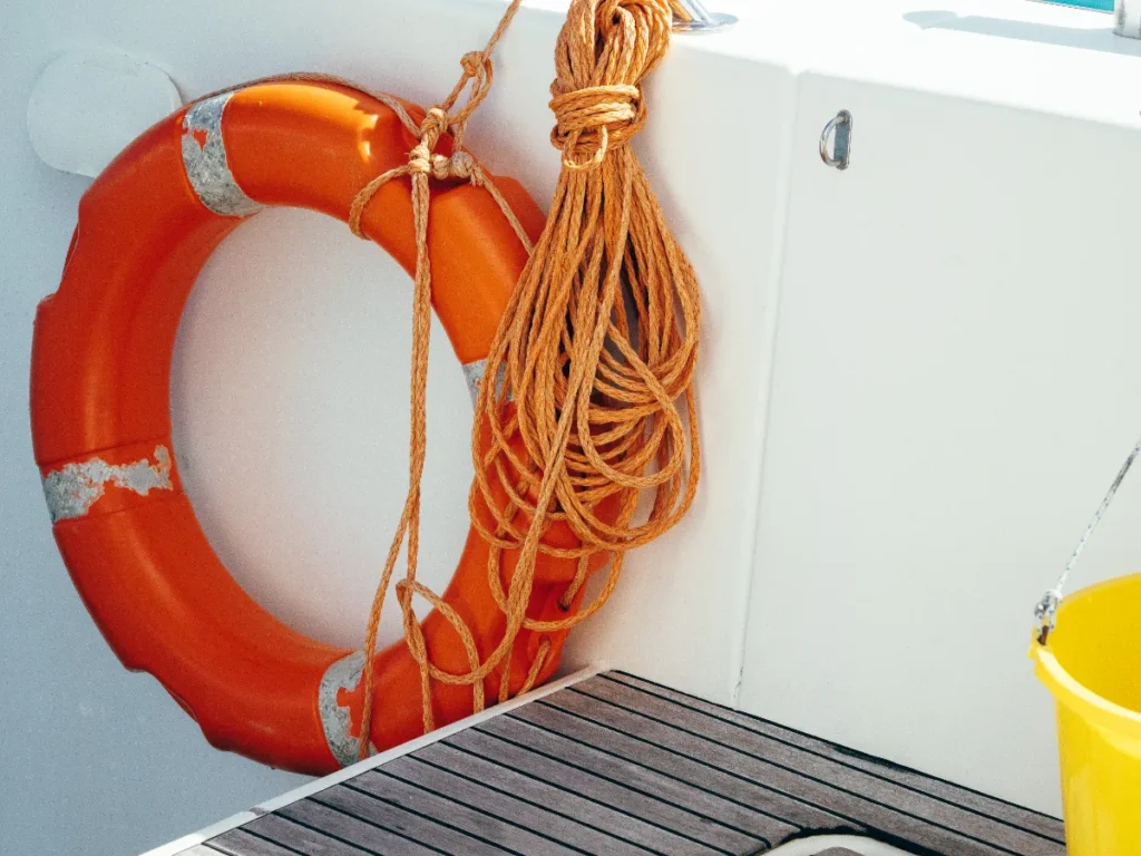 life ring and line hanging on the inside wall of a boat deck