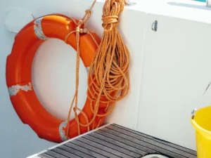 life ring and line hanging on the inside wall of a boat deck
